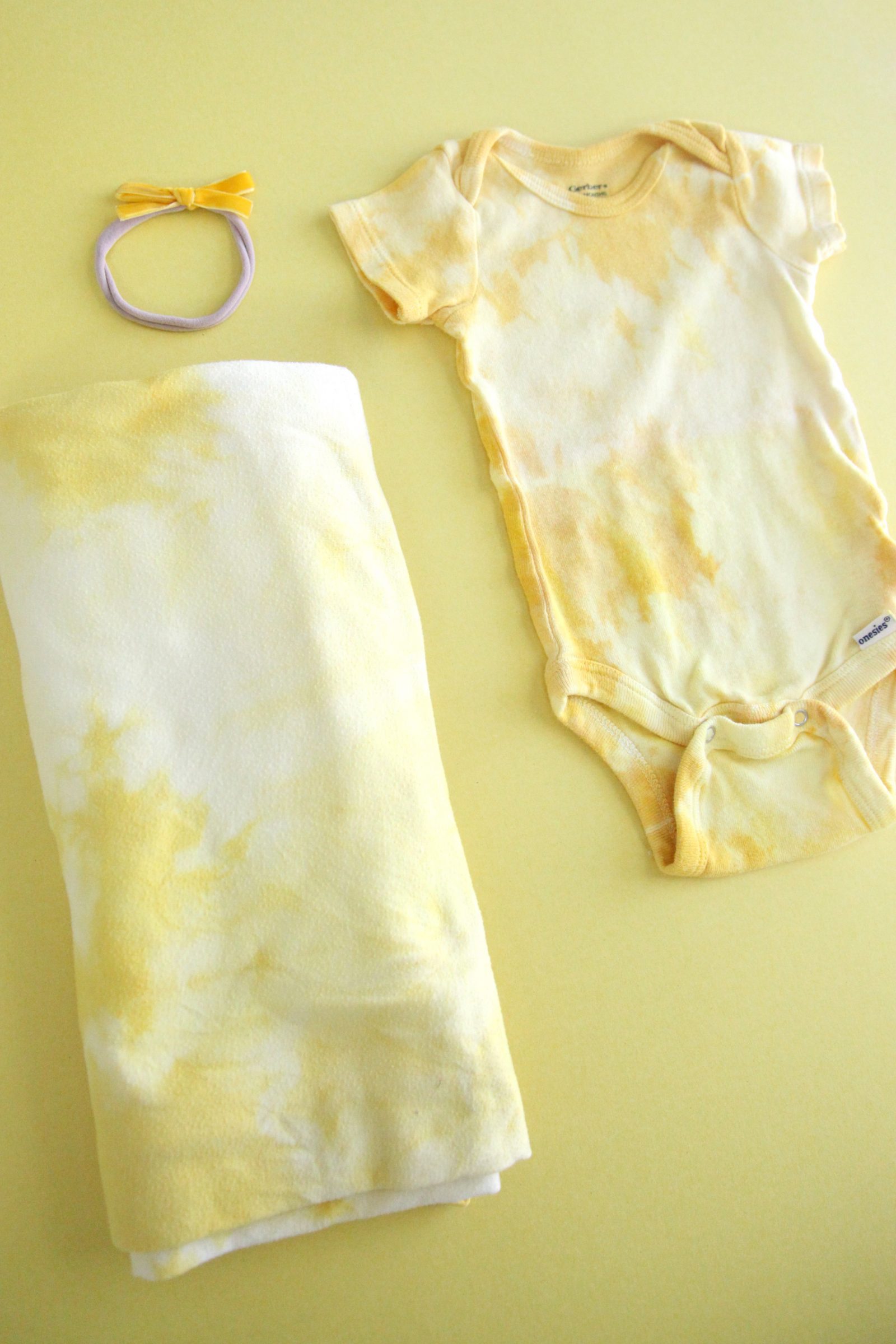 DIY Natural Turmeric Dye Tie Dye Onesies + a tutorial featured by Top US Craft Blog + The Pretty Life Girls